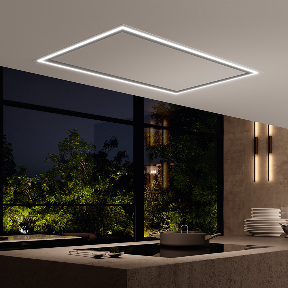 Hotte plafonnier WESCO Volano avec bandeau lumineux LED dimmable dans une cuisine ouverte moderne, de nuit.